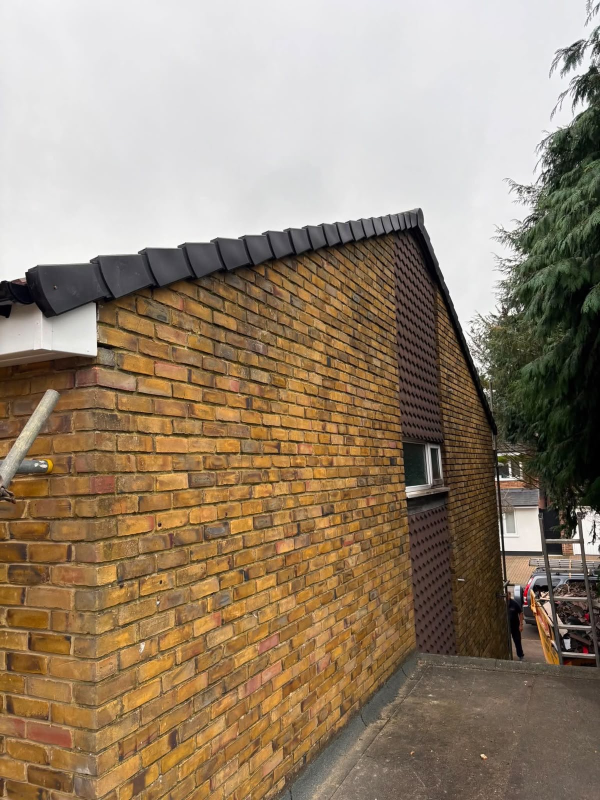New roof tiles on brick gable elevation