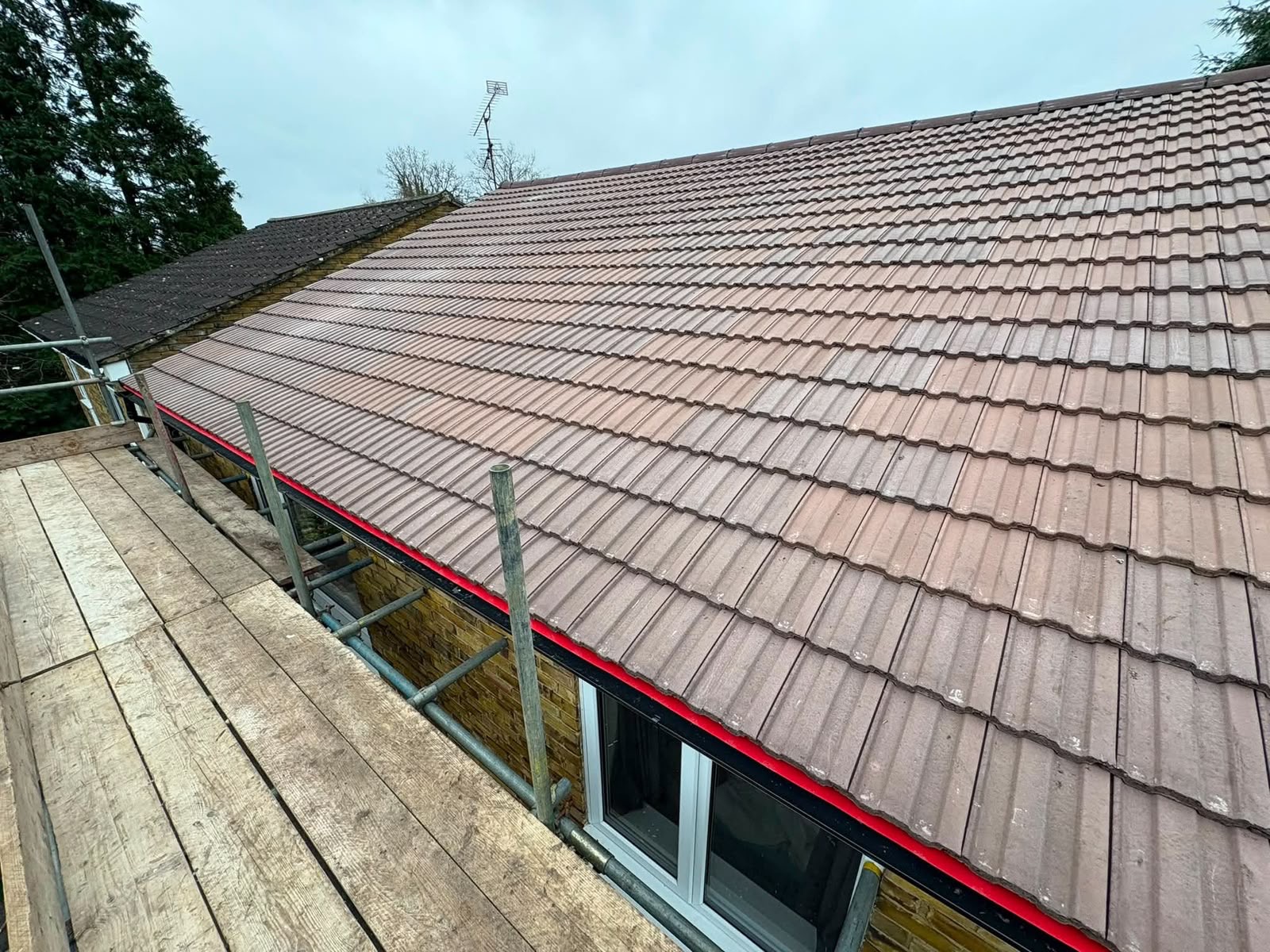 Terracotta roof with new black guttering